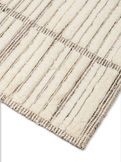 Close-up of a textured off white wool rug