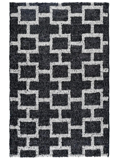 A hand woven area rug with a black and white geometric pattern