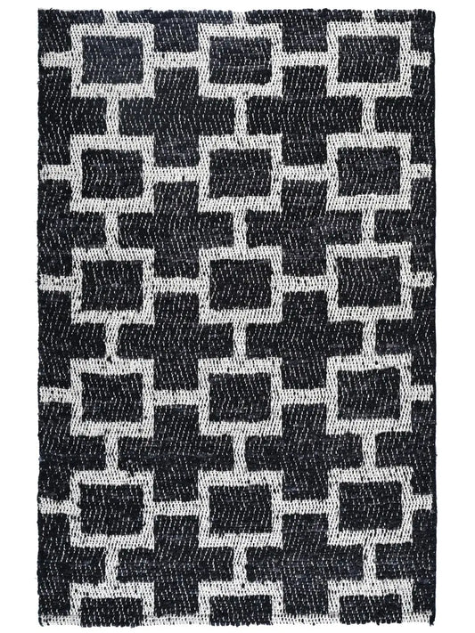 A hand woven area rug with a black and white geometric pattern