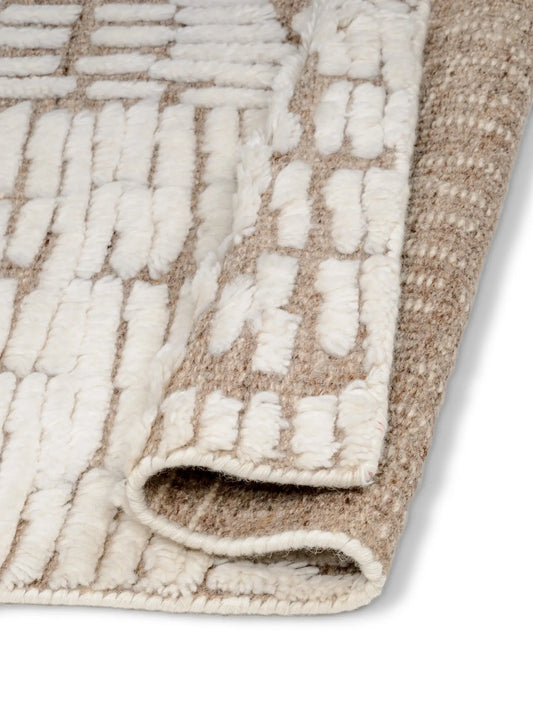textured beige and white area rug corner.