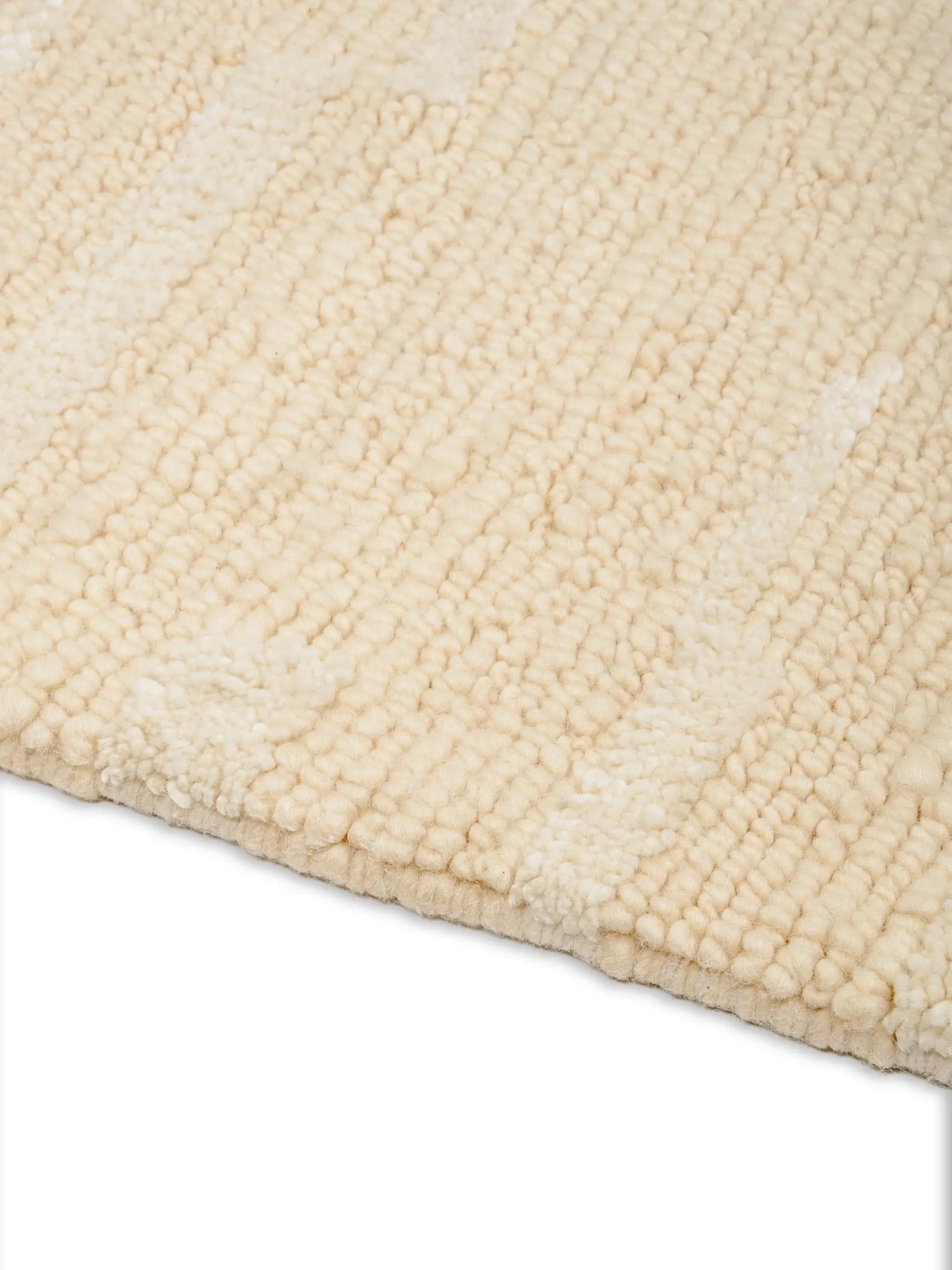 Close-up of a textured beige wool rug