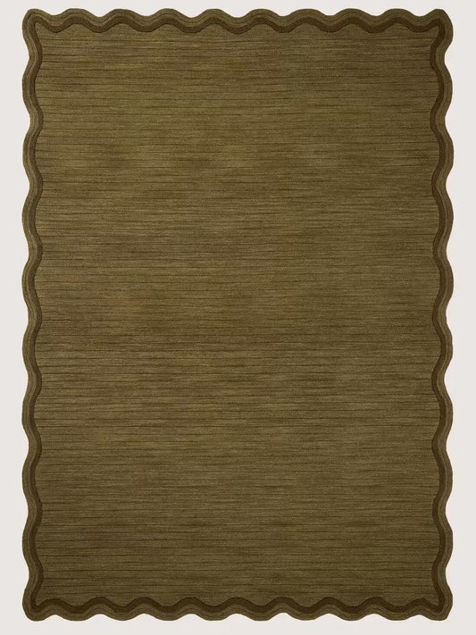 Brown hand tufted wool rug with a scalloped border