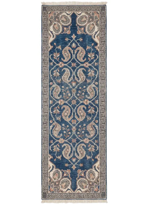 A traditional hand knotted wool runner rug with a deep blue central field