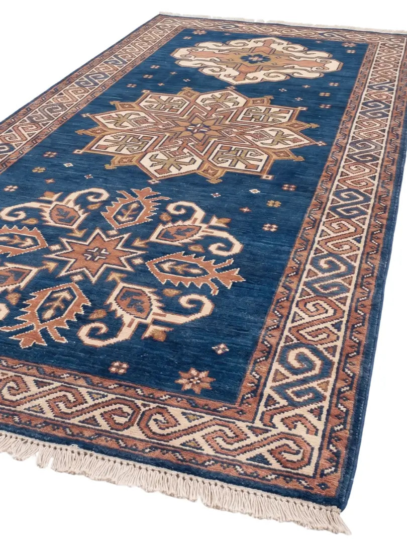 A rectangular wool area rug with a deep blue field