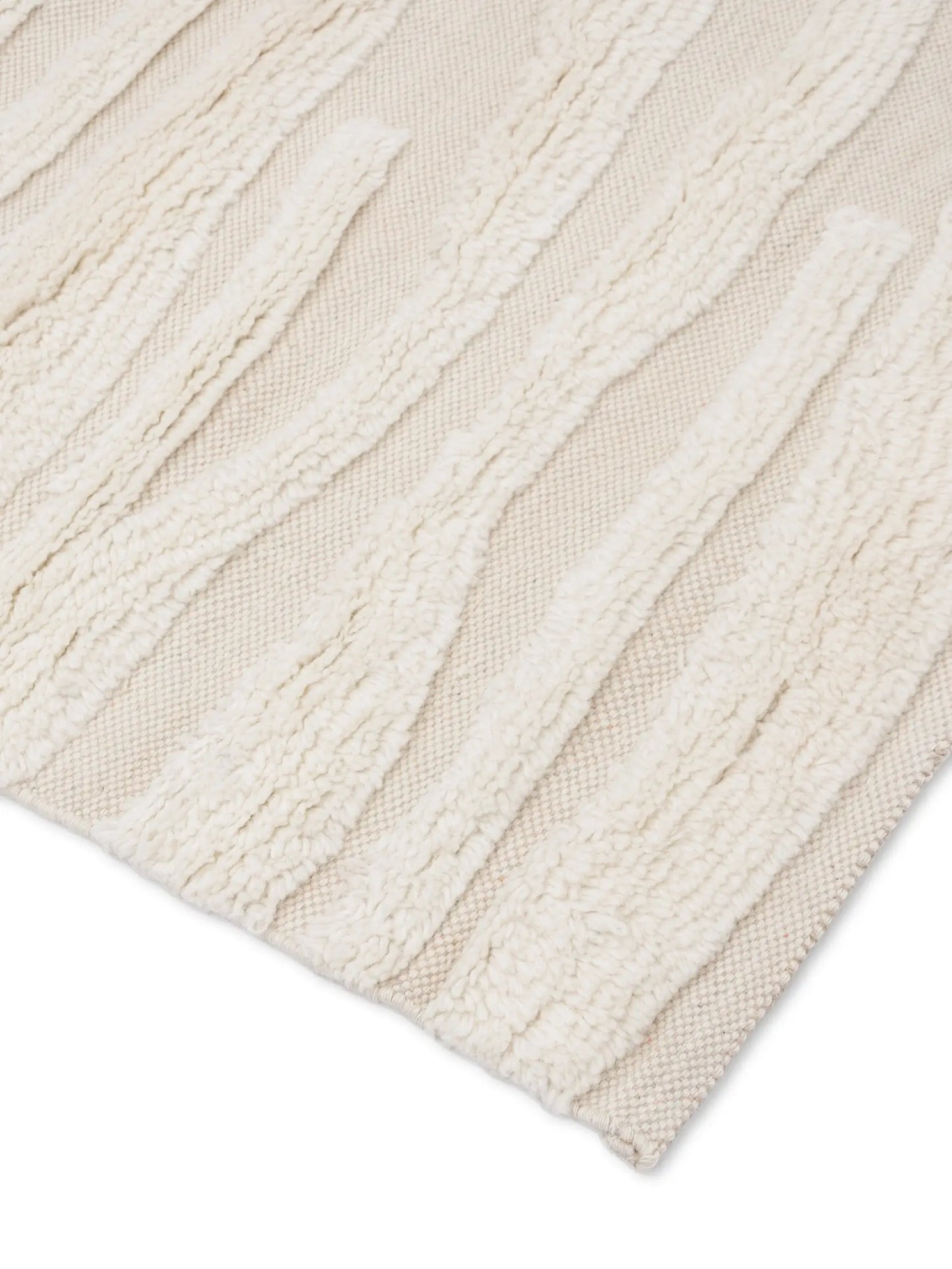 Close-up of a textured knotted beige rug