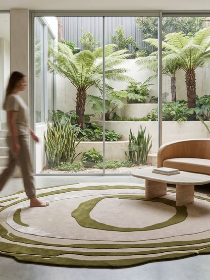 A modern living room scene with a large oval area rug