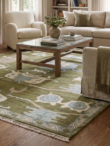 A styled living room with green hand knotteed area rug