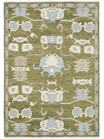 hand knotted area rug with a traditional geometric pattern in sage green