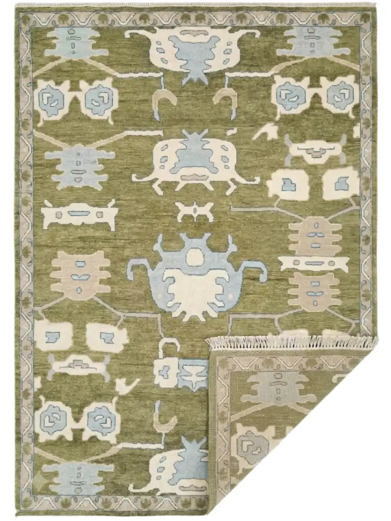 hand knotted area rug with a traditional geometric pattern