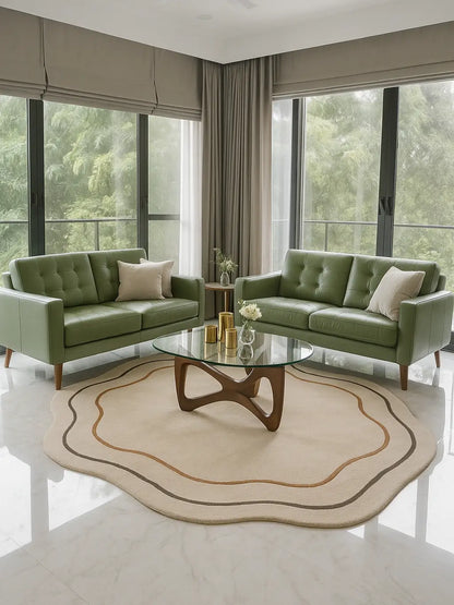 Modern living room with a beige shaped wol rug, a sofas, a glass coffee table, and large windows.