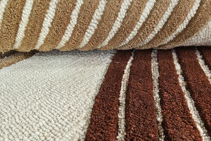 Close-up of a tufted wool rug with brown and beige stripes