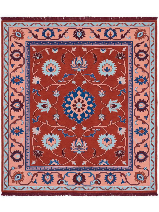 A square traditional area rug with a rust red center