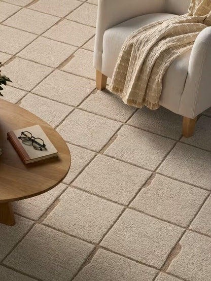 Beige tufted rug in the living area