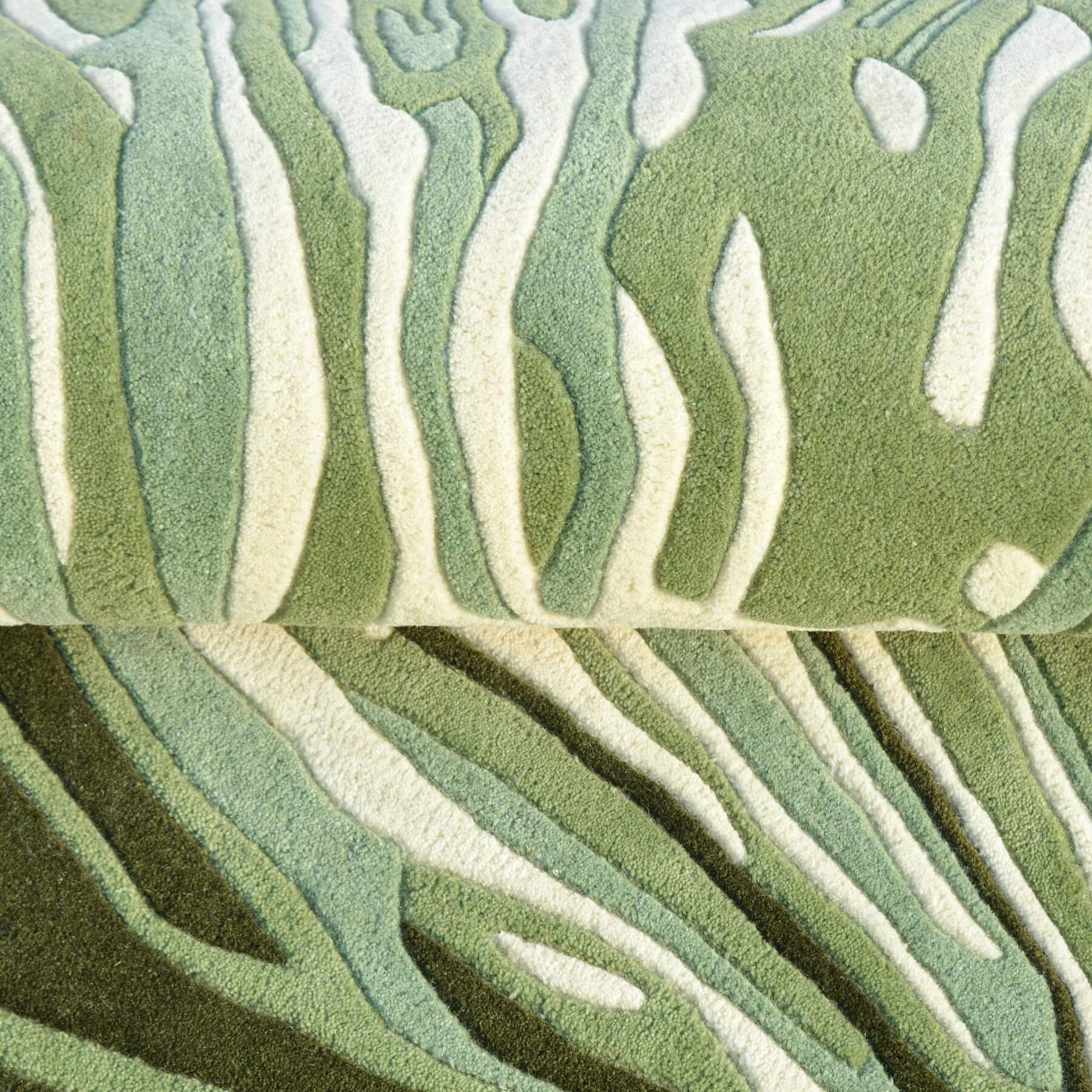 Close-up of green and beige patterned carpet