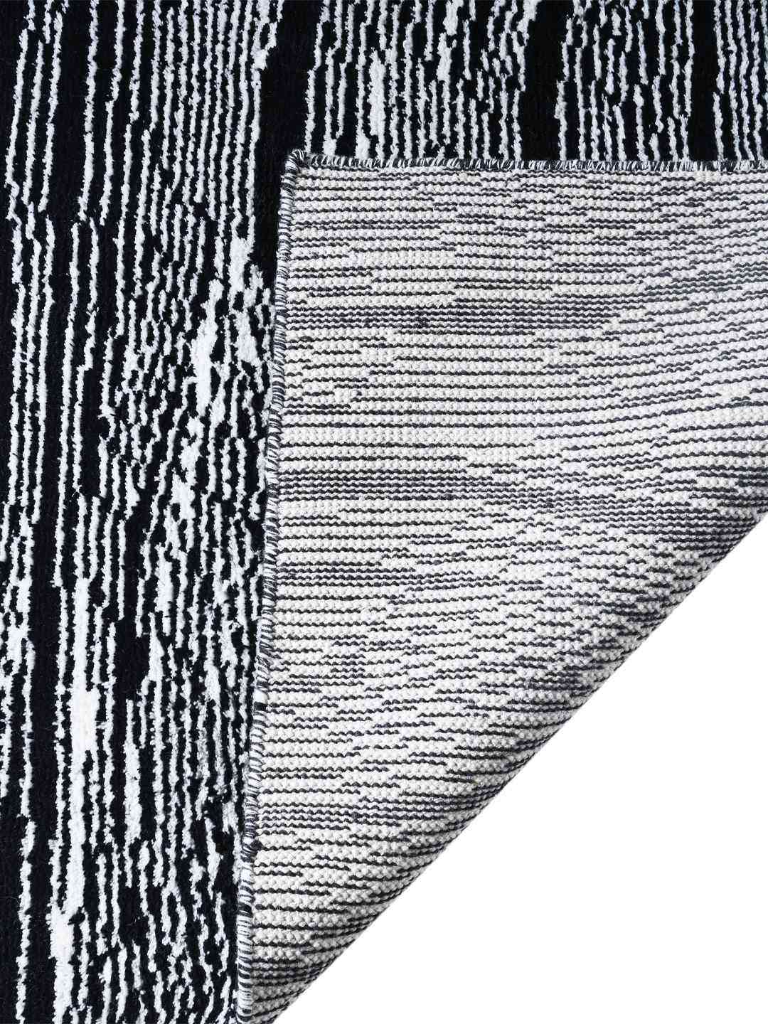 Close-up of a textured black and white rug corner back