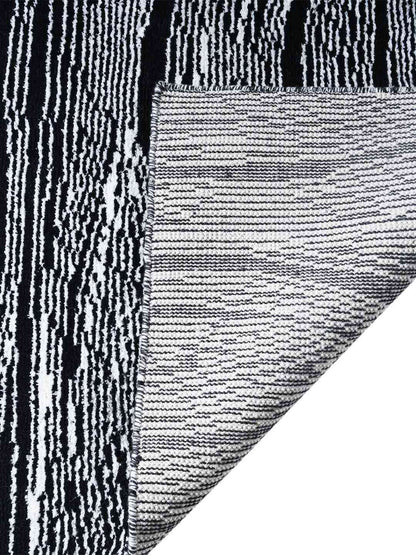 Close-up of a textured black and white rug corner back