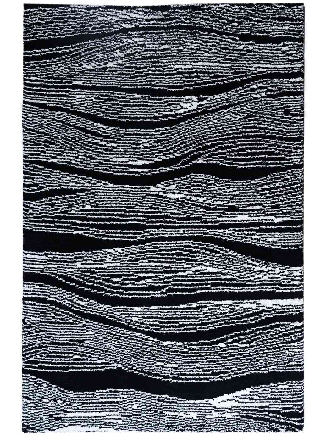 A rectangular area rug with an abstract wavy pattern in black and white