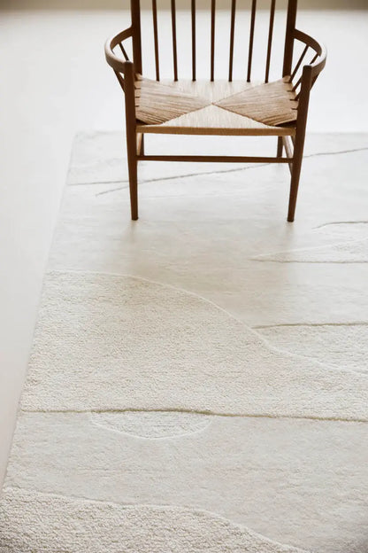 chair on white-textured New Zealand wool hand tufted rug