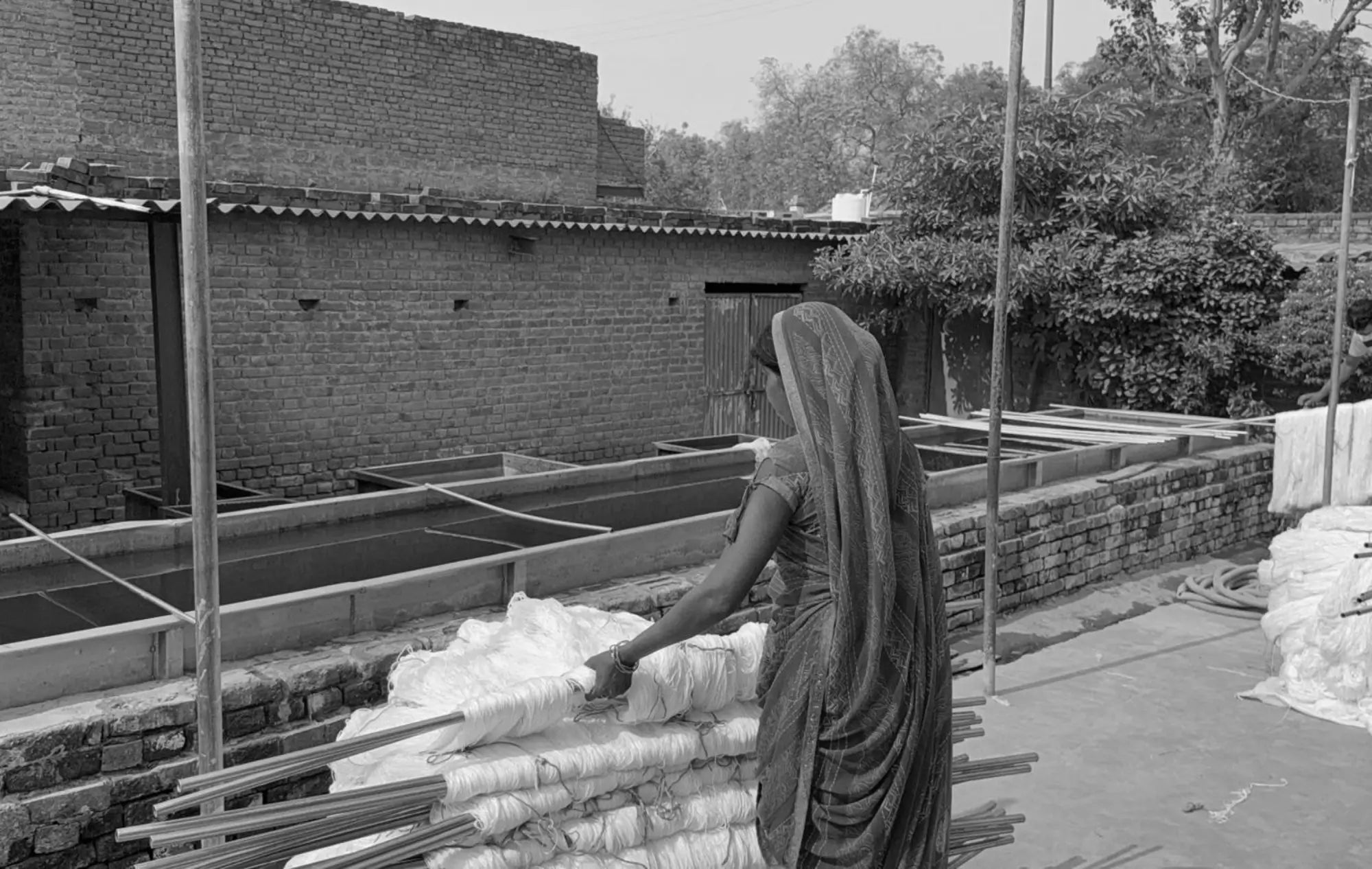 Woman working with yarn in rug mill